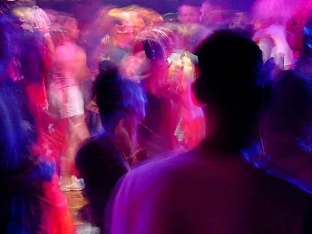 Rave Dancers in natural motion - experimental digital photography by Rick Doble. Candid handheld photograph taken at 2 or 4 seconds (see EXIF data below) with an early digital camera in 2002 and shot under available light. Effects were created with photography and not created with computer graphics.