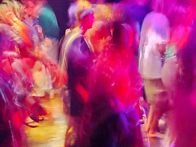 Rave dancers in natural motion - experimental digital photography by Rick Doble. Candid handheld photograph taken at 2 or 4 seconds (see EXIF data below) with an early digital camera in 2002 and shot under available light. Effects were created with photography and not created with computer graphics.
