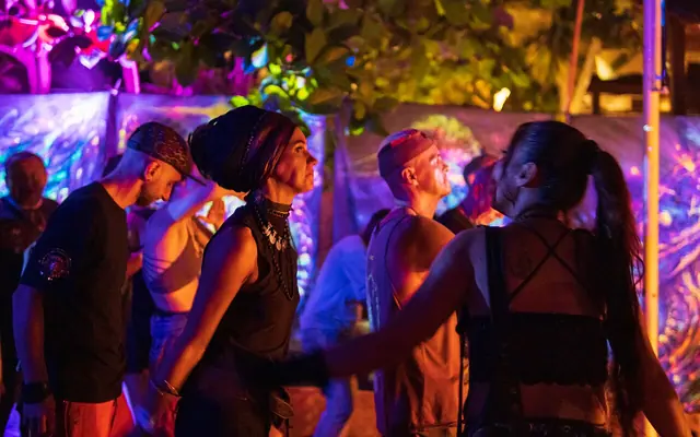 People dancing at a psychedelic trance party in Ashwem, Goa, India.